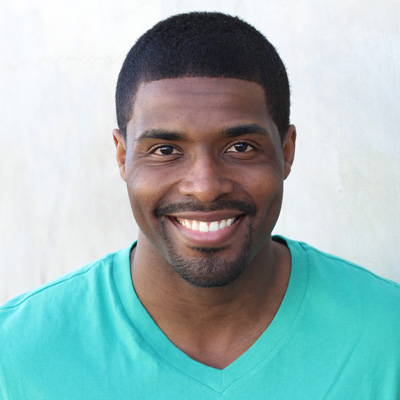 An elderly couple posing for a photo with smiles on their faces, embracing each other.